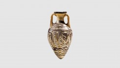 A Greek core-formed glass amphoriskos. 3rd century BC. 10.3cm high. From an esteemed American collection