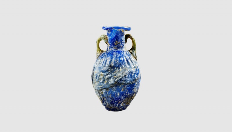 A Roman blue glass amphoriskos. 1st century AD. 5.75cm high. From an esteemed Am...