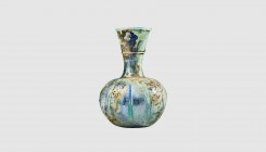 A Roman ribbed glass flask. 3rd-4th century AD. 15cm high. From an esteemed American collection