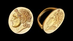 A Greek gold finger ring with the engraved portrait of Alexander the Great. Early 3rd century BC. 25mm long. Pollitt 14; Vollenweider 29. A magnificen...
