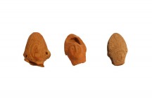 Three heads with Mitra, so-called bishops. Late Roman, 4th - 5th century A.D. Reddish brown and beige clay. All broken at the neck, 5-7 cm