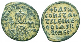 Basil I, the Macedonian. 867-886. AE follis. Constantinople mint, struck 870-879. + LЄOn ЬAS COnSτ AЧςς, crowned half-length facing busts of Basil, we...