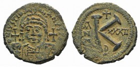 Justinian I (527-565). Æ 20 Nummi (28mm, 8.83g, 12h). Theoupolis (Antioch), year 32 (558/9). Helmeted and cuirassed bust facing, holding globus crucig...