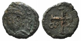Justinian I (527-565). Æ Nummus (9mm, 1.07g, 12h). Uncertain mint. Helmeted and draped facing bust. R/ Cross potent; ω - Λ across field; all within wr...