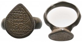 Byzantine Empire, c. 8th-12th century. Bronze ring with raised teardrop-shaped bezel engraved with deeply-cut linear design.

Condition: Very Fine

We...