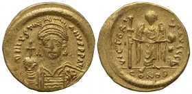 Justinian I (527-565); AV Solidus (g 4,48; mm 20,5; h 6); Constantinople, 538-545; Helmeted and cuirassed bust facing, holding globus cruciger and shi...