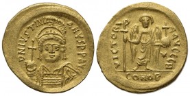 Justinian I (527-565); AV Solidus (g 4,48; mm 20,5; h 6); Constantinople, 545-565; Helmeted and cuirassed bust facing, holding globus cruciger and shi...