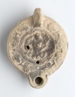 Roman Oil Lamp with Triton, 1st - 2nd century AD; height cm 5, length cm 11,3. Provenance: From the collection of a Diplomatic family since 1980s.