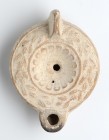 Roman Oil Lamp with Wreath around, 1st - 2nd century AD; height cm 5,5, length cm 12,5; Stamp on rear. Provenance: From the collection of a Diplomatic...