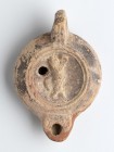 Roman Oil Lamp with Dancing Satyr, 1st - 2nd century AD; height cm 4,5, length cm 11. IVSTI inscribed on rear. Provenance: From the collection of a Di...