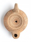 Roman Oil Lamp with Rays on Centre, 1st - 2nd century AD; height cm 4,5, length 11; Stamp on rear. Provenance: From the collection of a Diplomatic fam...