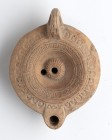 Roman Decorated Oil Lamp, 1st - 2nd century AD; height cm 5, length cm 11; Stamp on rear. Provenance: From the collection of a Diplomatic family since...