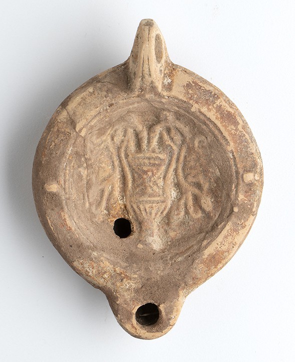 Roman Oil Lamp with Kantharos and Flowers, 1st - 2nd century AD; height cm 4,7, ...