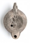 Roman Oil Lamp with Rudder and Fishes, 1st - 2nd century AD; height cm 4,5, length cm 11; Stamp on rear. Provenance: From the collection of a Diplomat...