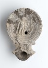 Roman Oil Lamp with Winged Eros, 1st - 2nd century AD; height cm 3, length cm 11. Provenance: From the collection of a Diplomatic family since 1980s.