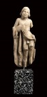 Greek Hellenistic Marble Grottesque Figure, 2nd - 1st century BC; height cm 24; Depicted standing, resting on a pillar, in the act of lifting the robe...
