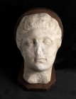 Roman Marble Head of a Woman, 1st century BC - 1st century AD; height (with wooden support) cm 16,8; height cm 21. An elegant head in high relief depi...