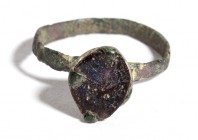 Reinassance Bronze Ring with Violet Glass, 15th - 16th century; diam cm 1,8. Provenance: English private collection.