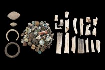 Group of Several Roman Items, 1st - 3rd century AD; length max cm 9; Composed by glass-paste pearls, bone dolls, two lead bracelets and two sling bull...