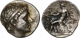 SELEUKID KINGDOM. Antiochos II Theos (261–246 BC). Drachm. Perhaps Tralles.
Obv: Diademed head right.
Rev: BAΣIΛEΩΣ ANTIOXOY.
Apollo seated left on om...