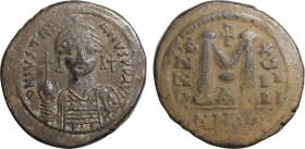 JUSTINIAN I (527-565). Follis. Nicomedia.
Obv: D N IVSTINIANVS P P AVG.
Helmeted and cuirassed facing bust, holding globus cruciger and shield; cross ...