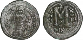 JUSTINIAN I (527-565). Follis. Nicomedia. Dated RY 18 (544/5).
Obv: D N IVSTINIANVS P P AVG.
Helmeted and cuirassed bust facing, holding globus crucig...