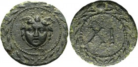 Time of Augustus to Claudius 
Mythologic tessera early first century BC, Æ 4.86 g. Facing head of winged Medusa, within laurel wreath. Rev. XI within...