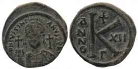 Justinian I. AD 527-565. Dated RY 12=AD 538/9. Constantinople Half follis AE 
Helmeted and cuirassed bust facing, holding globus cruciger and shield, ...