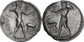 Greek Italy. Bruttium, Kaulonia. AR Stater, c. 525-500 BC. Apollo advancing right, holding branch in right hand, left arm extended, upon which a small...