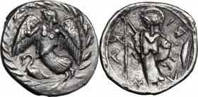 Sicily. Kamarina. AR Litra, 461-435 BC. Nike flying left; below, swan; all within wreath. / KA-M-A-RI (retrograde). Helmeted Athena standing left, hol...
