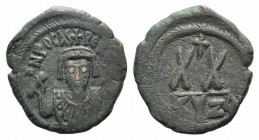 Phocas (602-610). Æ 20 Nummi (23mm, 5.82g, 12h). Cyzicus. Crowned bust facing, wearing consular robes, and holding mappa and cross. R/ Large XX; cross...