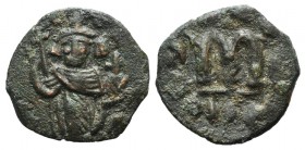 Arab-Byzantine, c. 660s-680s. Æ Fals (22mm, 3.39g, 6h), Emperor standing facing, holding long cross and globus cruciger. R/ Cursive M. Cf. Album 3504....