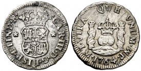 1764. Carlos III. Lima. JM. 1/2 real. (AC. 115). 1,52 g. Columnario. Sin punto sobre la marca de ceca. Rayitas y leves concreciones. Escasa. MBC-.