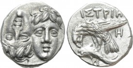 MOESIA. Istros. Drachm (4th century BC). 

Obv: Facing male heads, the left inverted.
Rev: ΙΣΤΡΙΗ. 
Sea eagle left, grasping dolphin with talons; ...