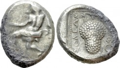 CILICIA. Soloi. Stater (Circa 410-375 BC). 

Obv: Amazon kneeling left, stringing bow.
Rev: ΣOΛΕΩN. 
Grape bunch on vine; monogram to right; all w...