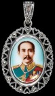 Thailand, Rama V Badge, an oval miniature facing portrait of Chulalongkorn in uniform wearing medals, in openwork silver frame with suspension loop an...