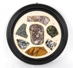 LITHOTHÈQUE
21th century
diam. cm 45

Collection of ancient and rare marbles, polished in modern times and arranged in a black frame as precious f...