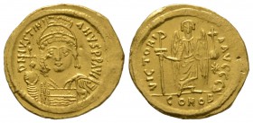Justinian I (527-565), Solidus, Constantinople, 545-565, 4.44g, 21mm. Helmeted and cuirassed bust facing, holding globus cruciger and shield / Angel s...
