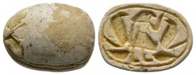 Second Intermediate Period, c. 1650-1550 B.C. Steatite scarab (20x14mm). Base engraved with a male figure standing right, flanked by two Uraei (Royal ...