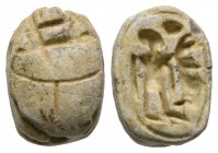 Second Intermediate Period, c. 1650-1550 B.C. Steatite scarab (14x10mm). Base crudely engraved with a human figure standing. Minor chips and wear, onc...