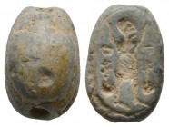 Second Intermediate Period (?), c. 1650-1550 B.C. Pale blue scarab (16x10mm). Base engraved with human figure with raised hands (in the symbolic gestu...
