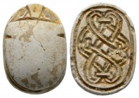 Second Intermediate Period, c. 1650-1550 B.C. Steatite scarab (22x16mm). Base engraved with a coiled cord pattern. Intact, once glazed, pierced for mo...