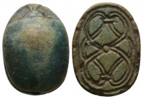Second Intermediate Period, c. 1650-1550 B.C. Steatite scarab (23x18mm). Base decorated with a coiled cord pattern. Intact, green glaze mostly preserv...
