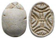 Second Intermediate Period, c. 1650-1550 B.C. Steatite scarab (14x11mm). Base engraved with a coiled cord pattern. Intact, once glazed, pierced for mo...