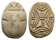 Second Intermediate Period, c. 1650-1550 B.C. Steatite scarab (16x11mm). Base engraved with a coiled cord pattern. Intact, once glazed, pierced for mo...