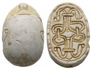 Second Intermediate Period, c. 1650-1550 B.C. Steatite scarab (20x13mm). Base engraved with a coiled cord pattern. Back decorated with two curls. Smal...