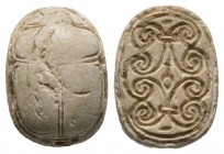 Second Intermediate Period, c. 1650-1550 B.C. Steatite scarab (17x12mm). Base engraved with a sign for goodness and beauty surrounded by spiral scroll...