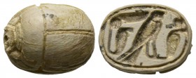 Second Intermediate Period, c. 1650-1550 B.C. Steatite scarab (17x13mm). Base engraved with a falcon flanked by two Uraei (Royal cobras). Intact with ...