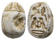 Second Intermediate Period, c. 1650-1550 B.C. Steatite scarab (16x11mm). Base engraved with two Uraei (Royal cobras) and two falcons. Chipped on the b...