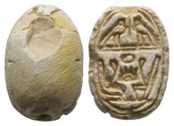 Second Intermediate Period, c. 1650-1550 B.C. Steatite scarab (16x11mm). Base engraved with symmetrical signs, on top two Horus falcons, below two cro...